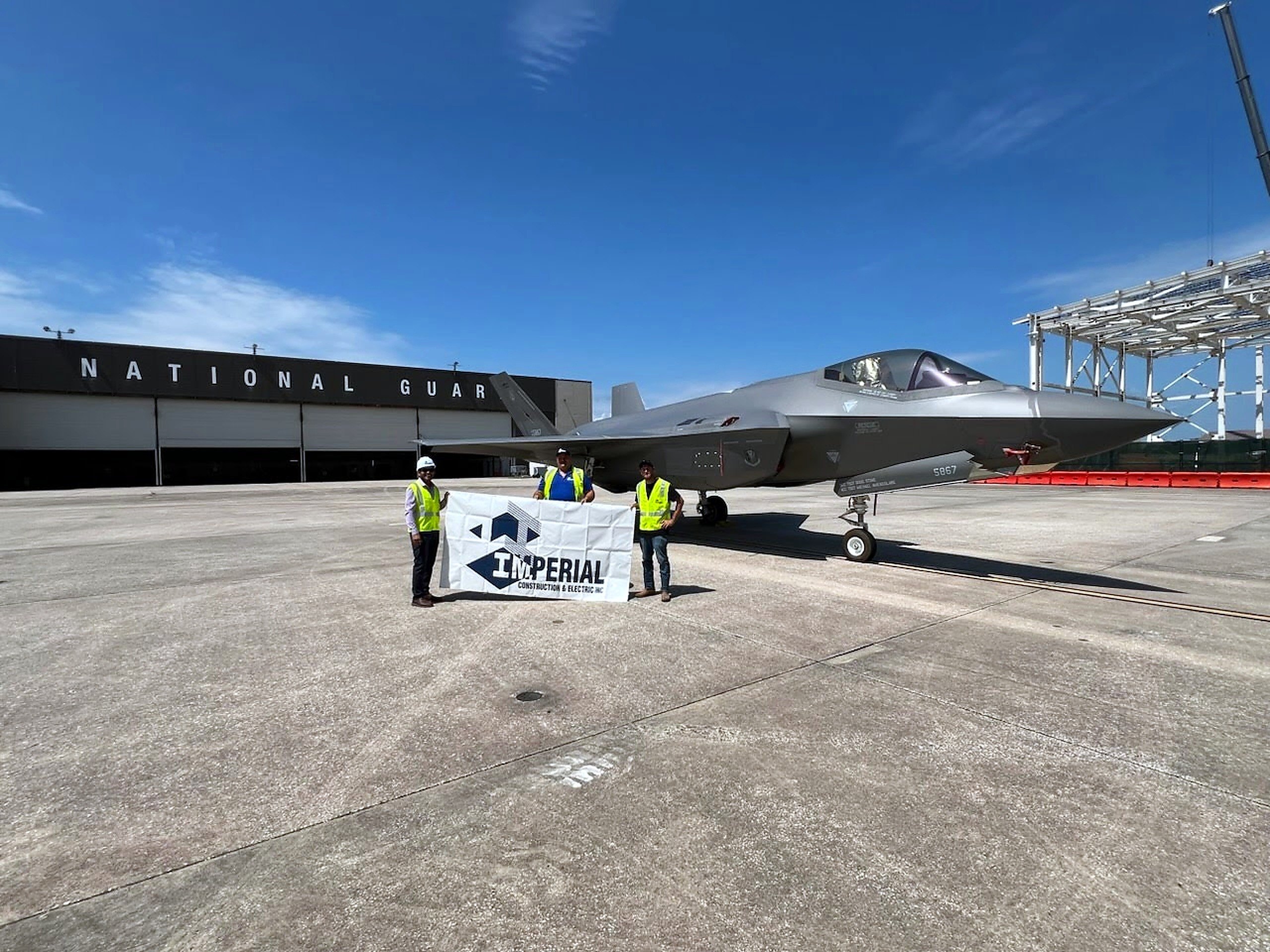 Imperial Construction & Electric team on the apron in front of an F-35 at the Air National Guard hangar in Jacksonville, Florida